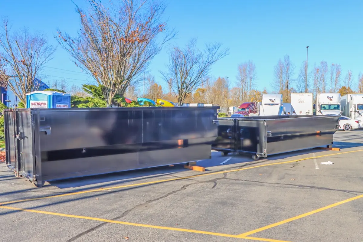 Professional dumpster rental service with roll-off container on residential driveway in Lower Burrell